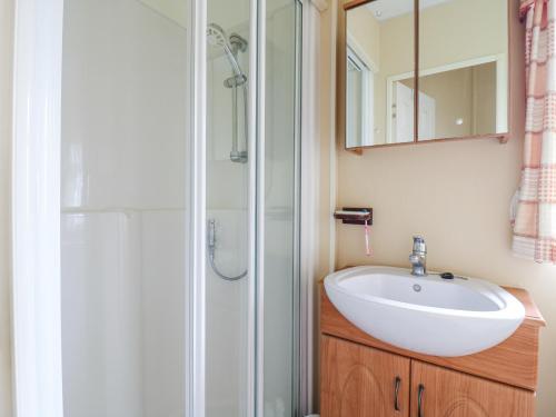 a bathroom with a sink and a shower at 120 Caravan in Great Yarmouth
