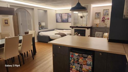 a living room with a kitchen and a bedroom at appartamento comfort Malpensa check in h 24 posto auto privato in Casorate Sempione