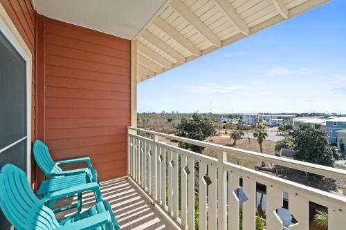two chairs on a porch with a view of the beach at Waterside Village by Panhandle Getaways in Mexico Beach