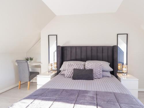 a bedroom with a large bed and a desk at 3 The Granary in Banff