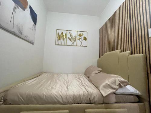 a small bedroom with a bed in the corner at Filed Residences Hotel Apartment in Manila