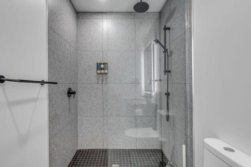 a shower with a glass door in a bathroom at Initial / Simplicity / Québec in Quebec City