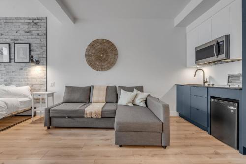 a living room with a couch and a bed at Initial / Simplicity / Québec in Quebec City