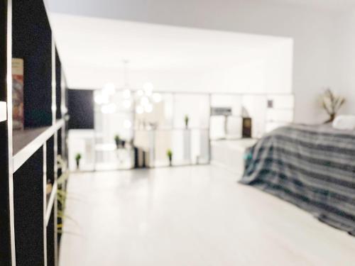 a bedroom with a bed and a white floor at Old Town Loft in Bucharest