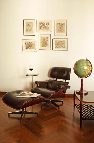 a living room with a chair and a table at Hotel Fasano Sao Paulo in Sao Paulo