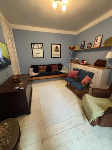 a living room with a couch and a table at Tenby Victorian Villa with parking, pets allowed in Pembrokeshire