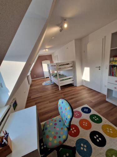 a living room with a chair and a rug at Ferienhaus Urlaub-in-Edenkoben in Edenkoben