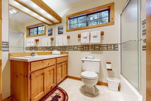 a bathroom with a toilet and a shower and a sink at Circle 4 Ranch 31 | Discover Sunriver in Sunriver