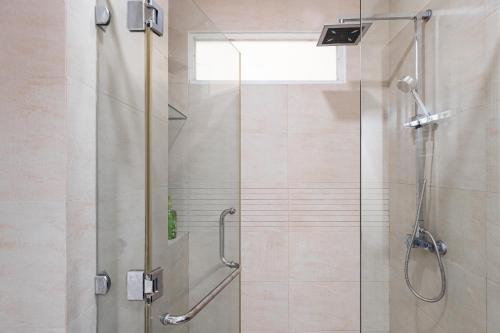 a shower with a glass door in a bathroom at NEW Premium 5BRs 4WC local house centre town in Ho Chi Minh City