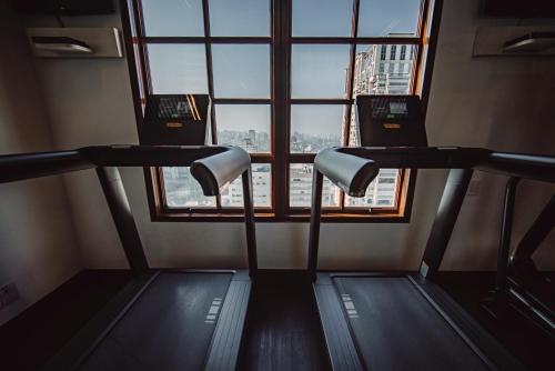 a gym with two treadmills in front of a window at Hotel Fasano Sao Paulo in Sao Paulo