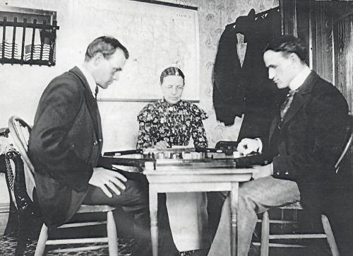 a group of three men playing a game at a table at Elkader Jailhouse Inn in Elkader