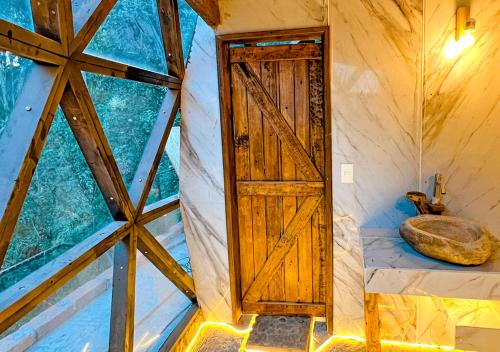 a room with a door in a tree house at Finca San Pedro in Hacienda Santa María