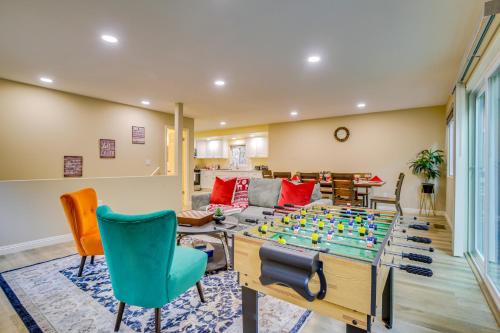 a living room with a table with a game at 4 Mi to Lake Arrowhead Cabin with Grill and Deck! in Twin Peaks
