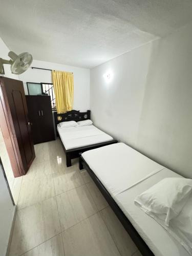 a room with two beds and a window at Hotel el saman in Bucaramanga