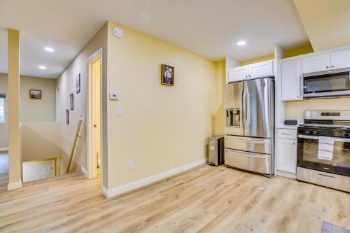 a kitchen with white cabinets and a wooden floor at 4 Mi to Lake Arrowhead Cabin with Grill and Deck! in Twin Peaks