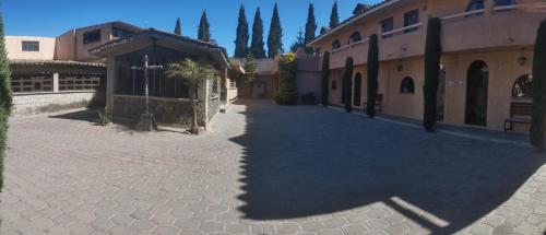 a shadow of a building on a street at Hosteria Covadonga in Perote