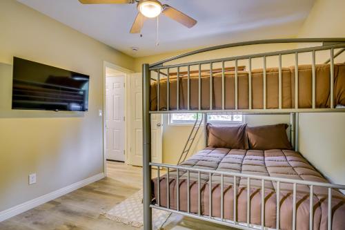 a bedroom with a bunk bed and a flat screen tv at 4 Mi to Lake Arrowhead Cabin with Grill and Deck! in Twin Peaks