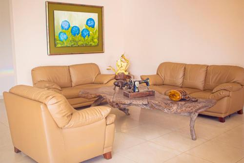 a living room with two couches and a coffee table at Gran Hotel De Lago - El Coca in Puerto Francisco de Orellana