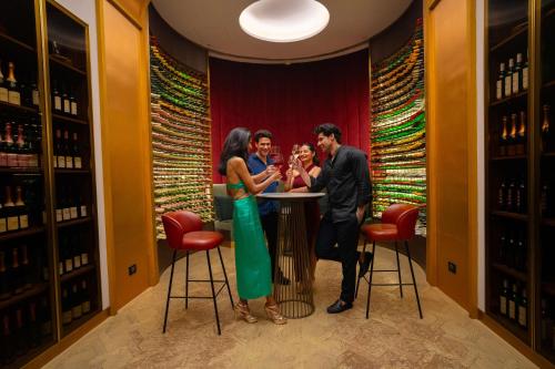 a group of people standing at a bar in a wine cellar at Radisson Blu Hotel & Spa, Nashik in Nashik