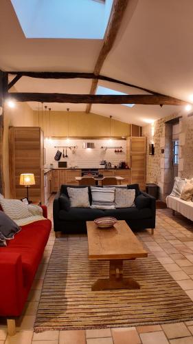 a living room with a couch and a table at Repos à Ribérac B&B in Ribérac