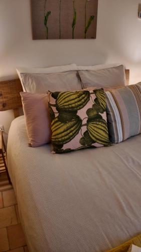 a bed with two pillows on top of it at Repos à Ribérac B&B in Ribérac