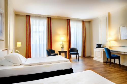 Ένα ή περισσότερα κρεβάτια σε δωμάτιο στο Welcome Hotel Residenzschloss Bamberg