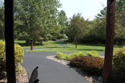 a view of a path in a park with trees at 2 Bedroom accessible condo in Eagle River