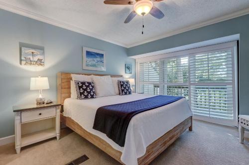 a bedroom with a bed with a ceiling fan and a window at 2006 Beachwood in Fernandina Beach