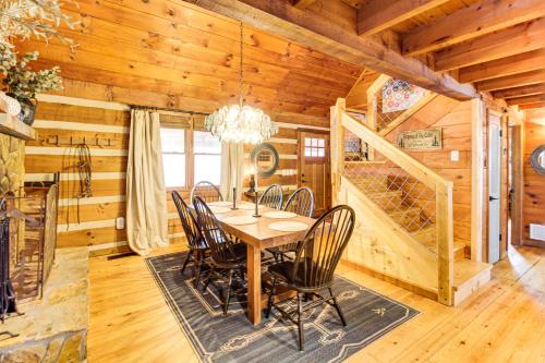 a dining room with a table and chairs in a cabin at 3 Mi to Dtwn Ellijay Tree-Lined Cabin with Deck! in Ellijay