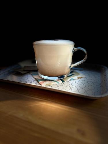a coffee cup sitting on a plate on a table at Sport relax hotel Na kopečku in Křinec