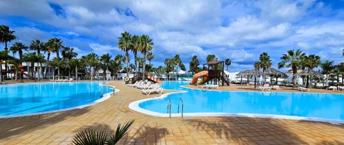 a pool at a resort with a slide at Blue Oasis in Corralejo