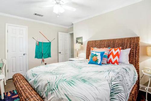 a bedroom with a large bed with colorful pillows at 96097 Piney Island in Fernandina Beach