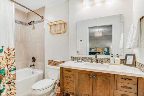 a bathroom with a sink and a toilet and a mirror at 96097 Piney Island in Fernandina Beach