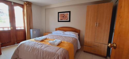 Postel nebo postele na pokoji v ubytování Illari Wari II-Hotel Sauna