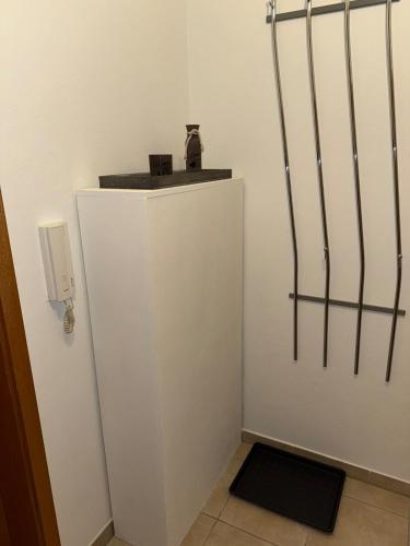 a small white wall with a phone on top of it at Cozy City Apartment Penzberg in Penzberg