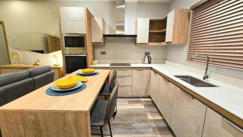 a kitchen with a table with two bowls on it at Modern Retreat - Comfort & Style in Hermitage