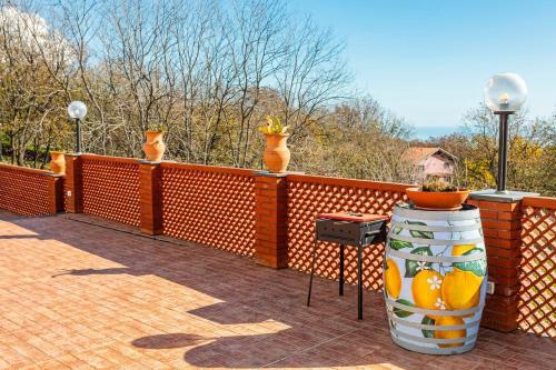 a fence with some vases on top of it at Camia Etna House in Piedimonte Etneo