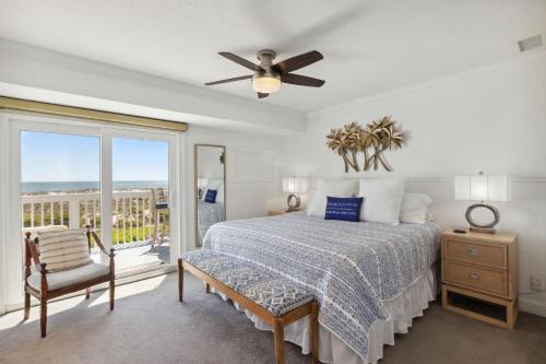 una camera da letto con un letto e un ventilatore a soffitto di 95100 Sandpiper a Fernandina Beach