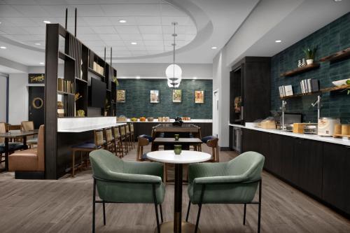 a restaurant with chairs and a table and a counter at Springhill Suites by Marriott Savannah Downtown Historic District in Savannah