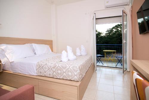 a bedroom with a bed with white shoes on it at Space AB central in Kalamata