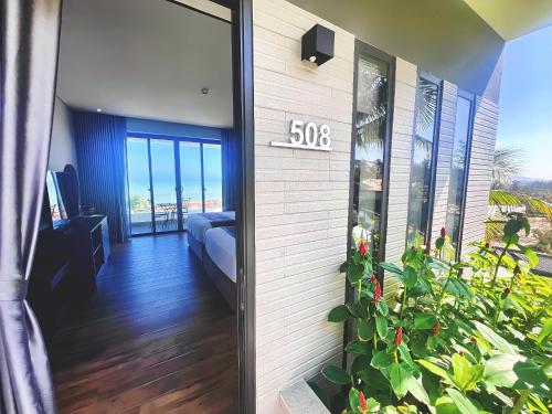 a front door of a house with a sign on it at Du Parc Mũi Né Resort - Sᴀɴᴅ ᴅᴜɴᴇ & ᴏᴄᴇᴀɴ ᴠɪᴇᴡ in Mui Ne
