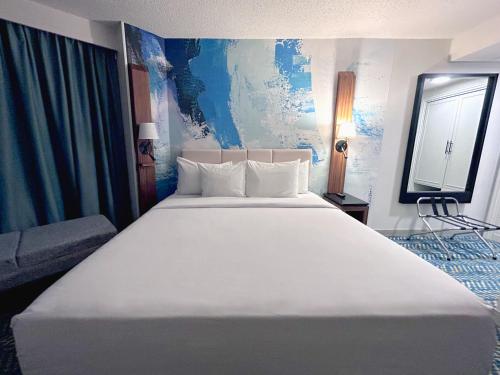 a large white bed in a hotel room at Fort Pontchartrain Detroit, a Wyndham Hotel in Detroit