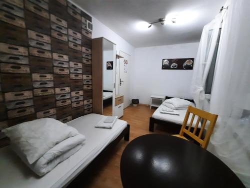 a small room with a bed and a chair at Lorf Hostel&Coffee in Kraków