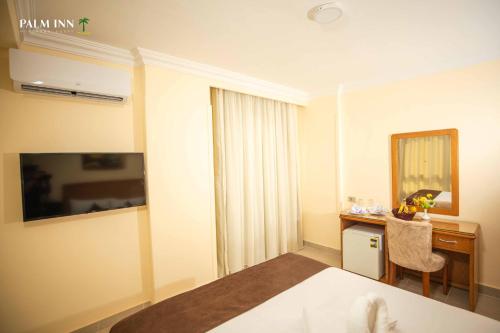 a hotel room with a bed and a desk at Palm Inn Hotel Hurghda in Hurghada