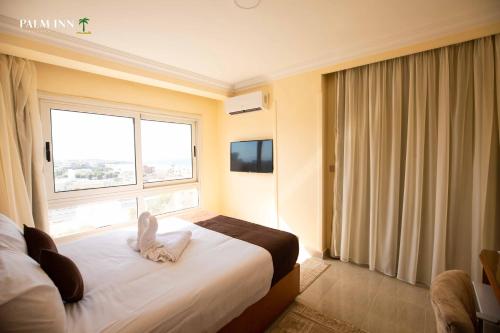 Postel nebo postele na pokoji v ubytování Palm Inn Hotel Hurghda