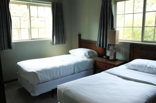 a hotel room with two beds and two windows at 2 bedroom condo at Wild Eagle Lodge, #133 in Eagle River