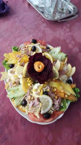 a plate of salad on a pink table at Hotel Espace Tifawine in Tafraoute