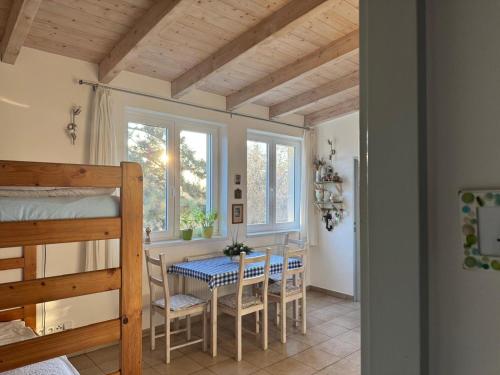 a dining room with a table and chairs and a bed at DIVADELNÍ PENZION in Bukovany
