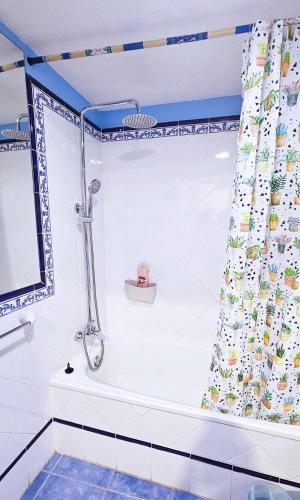 a shower in a bathroom with a shower curtain at Blue Oasis in Corralejo