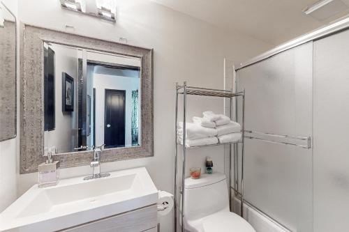 a bathroom with a sink and a toilet and a mirror at Scott Peak Lodges Condo in Alpine Meadows